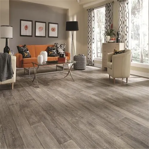 Cozy living room featuring an orange sofa, elegant armchairs, and wooden flooring.